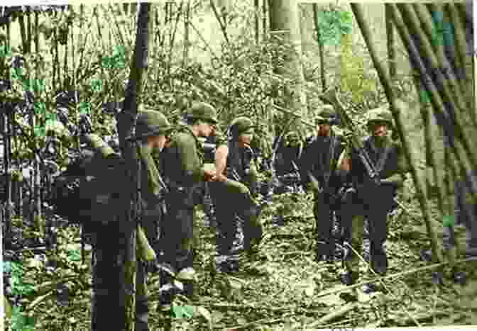 A Group Of American Soldiers Walking Through A Jungle In Vietnam. The Soldiers Are Armed With Rifles And Are Wearing Helmets And Fatigues. They Look Tired And Exhausted. Bravo: Blood Road (Bravo Saga 2)