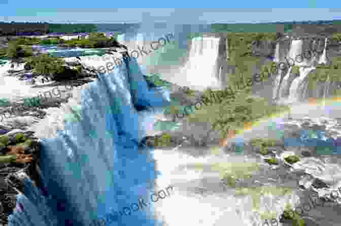 A Panoramic View Of Iguazu Falls, With Cascading Water And Rainbows In The Mist Trip Out To The Soul Of Brazil